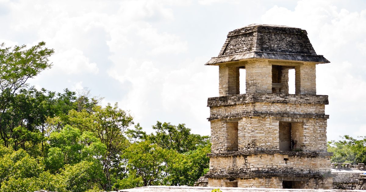 The tower of the palace at Palenque against green forest, Mexico