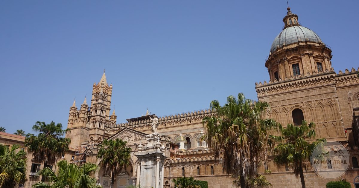 Palermo Cathedral with palm trees under a clear sky, Sicily