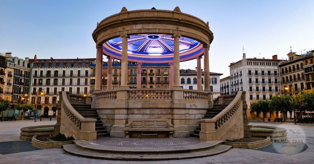A lit stone gazebo in a Pamplona plaza at twilight, Spain