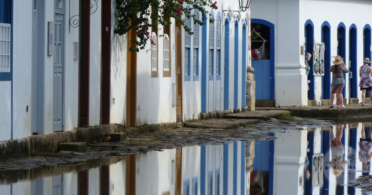 Colonial buildings reflected in the tide flooded streets of Paraty, Brazil