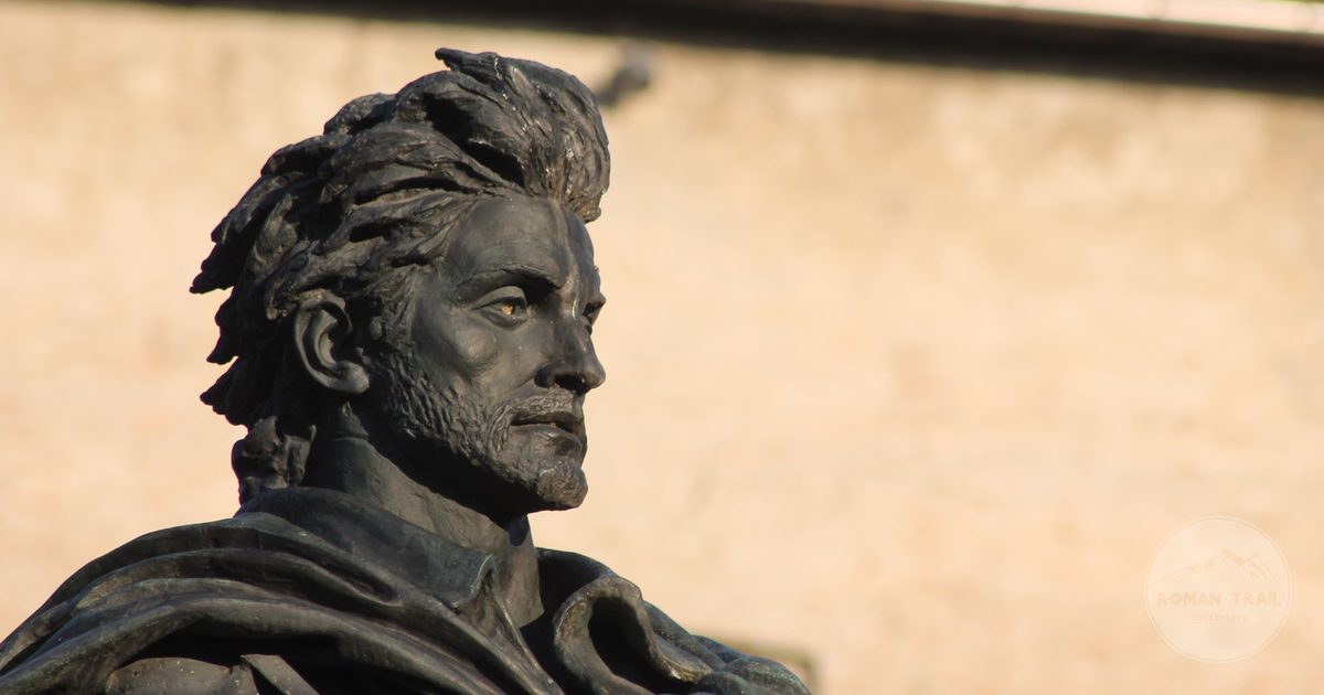 A bronze statue of a historical figure in Parma, Italy