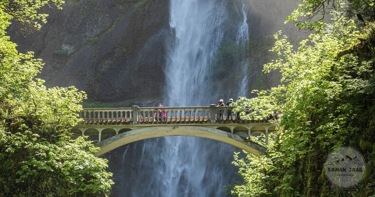 Multnomah Falls cascading behind the Benson Bridge in the green Columbia River Gorge, Oregon for women travelers