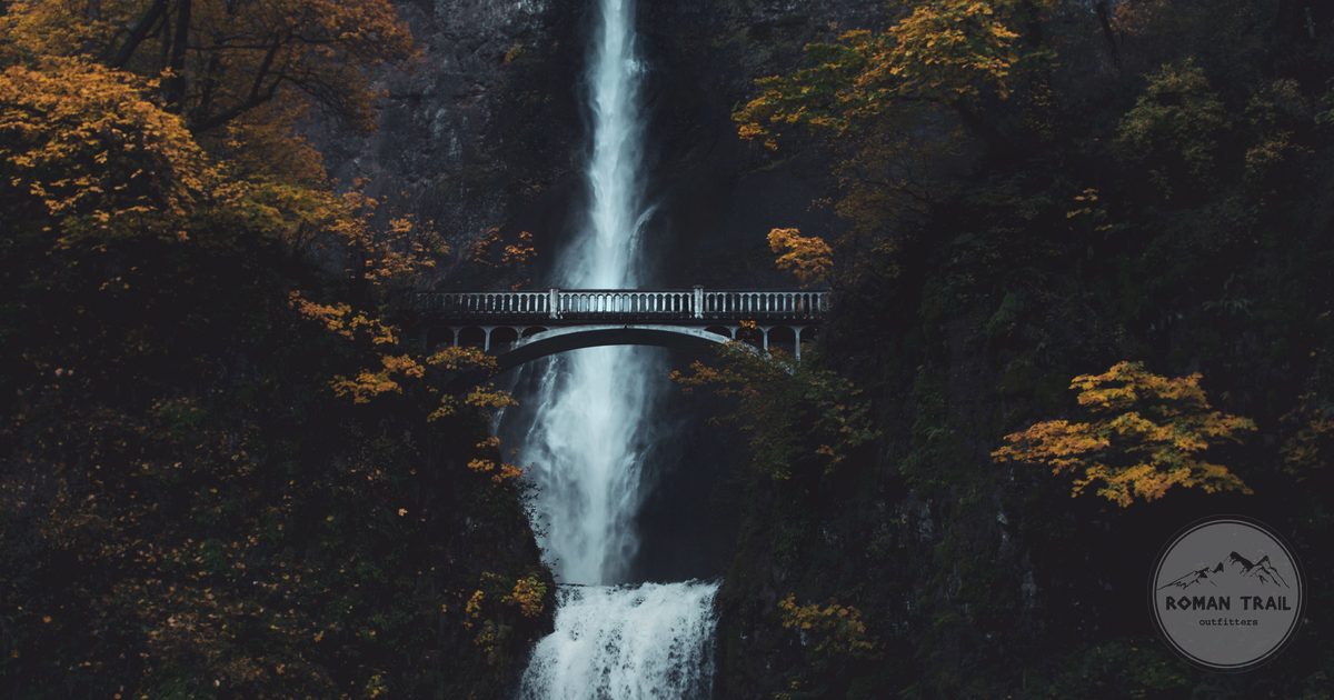 Multnomah Falls and the Benson Bridge framed by autumn foliage in the Columbia River Gorge, Oregon for women travelers