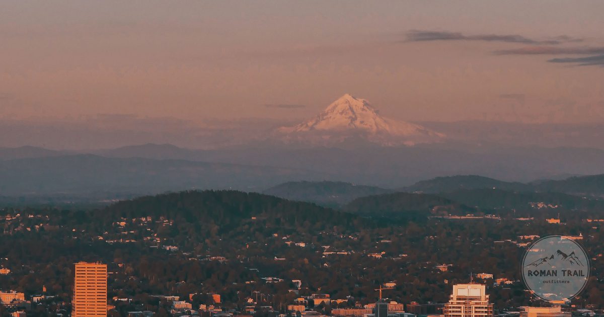 Snow capped Mount Hood above the Portland skyline at sunset, Portland travel guide for women by Roman Trail Outfitters