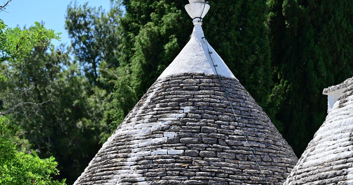 Trulli stone roofs among greenery in Alberobello, Puglia