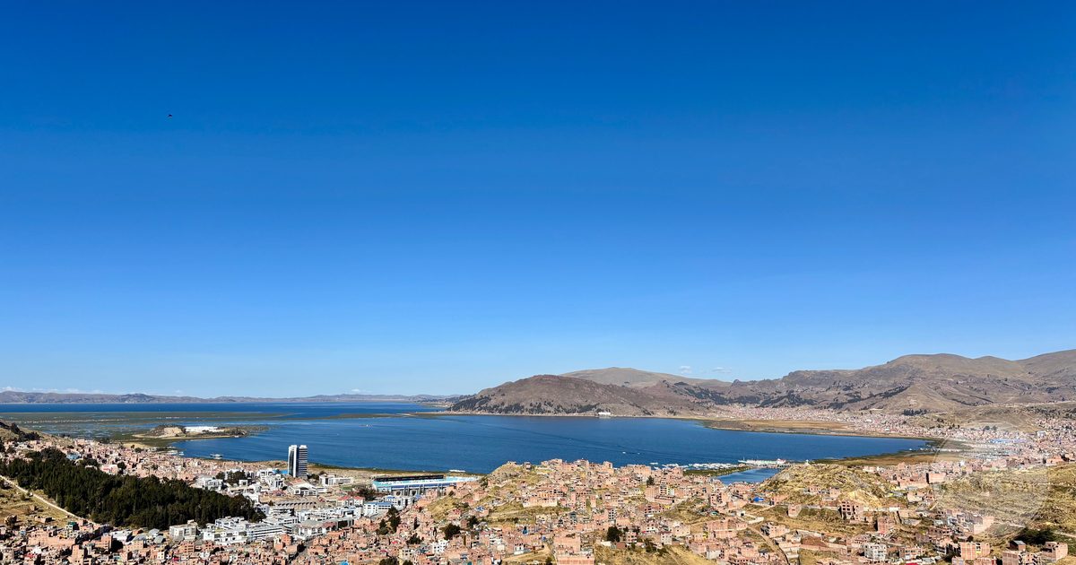 Aerial view of the city of Puno with Lake Titicaca behind it, Peru