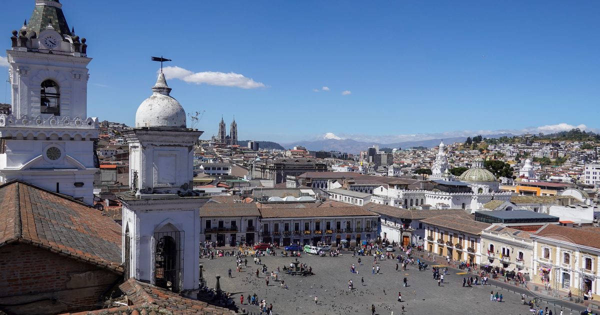 A busy plaza surrounded by colonial architecture in Quito's historic centre, Quito packing list for women by Roman Trail Outfitters