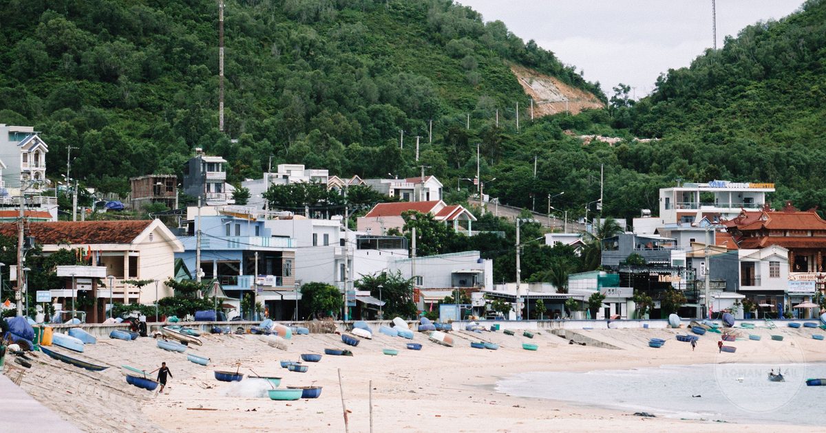 A beach and fishing village with moored boats at Quy Nhon, Vietnam