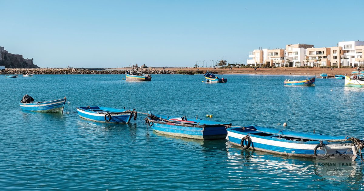 Colourful fishing boats on the Rabat coastline, Rabat packing list for women by Roman Trail Outfitters