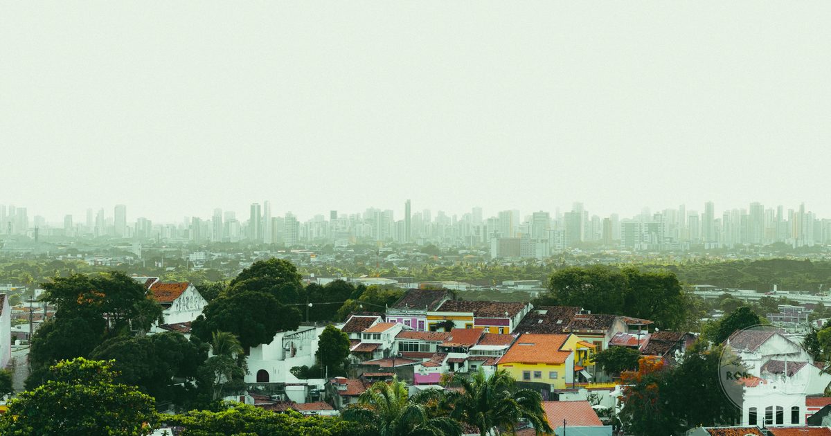 The colourful colonial architecture of Olinda with the Recife skyline behind it, Brazil