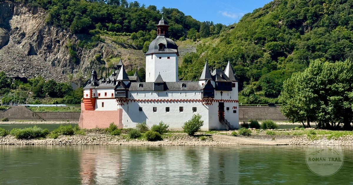 Pfalzgrafenstein Castle on its island in the Rhine below green hills, Germany