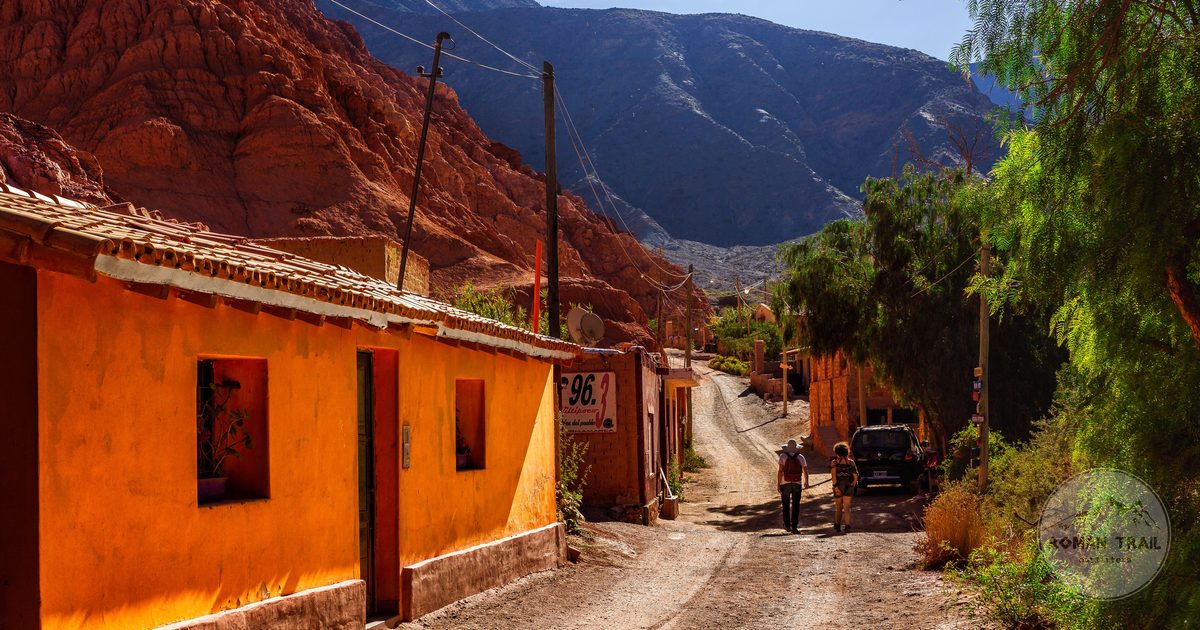 Colourful adobe buildings on a street in the northern Argentine highlands, Salta packing list for women by Roman Trail Outfitters