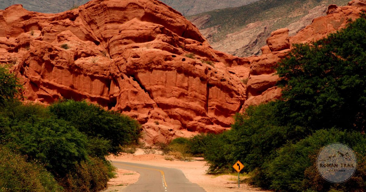 A winding road through the red canyon of Quebrada de las Conchas, Salta packing list for women by Roman Trail Outfitters