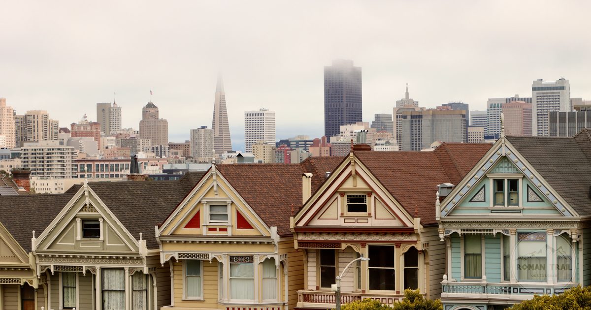 The Painted Ladies Victorian houses at Alamo Square with the fogged downtown skyline behind, San Francisco for women travelers