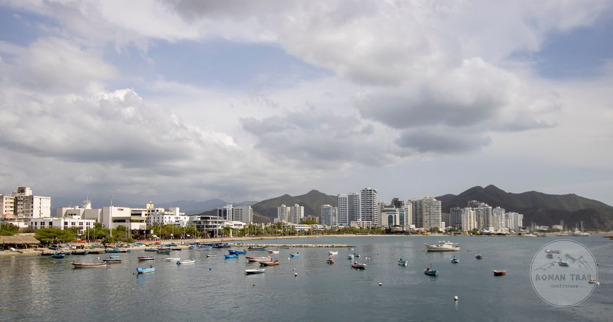 The skyline of Santa Marta with boats in front and mountains behind, Colombia