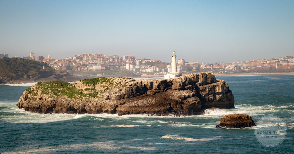 Mouro Island lighthouse with the Santander skyline behind, Spain