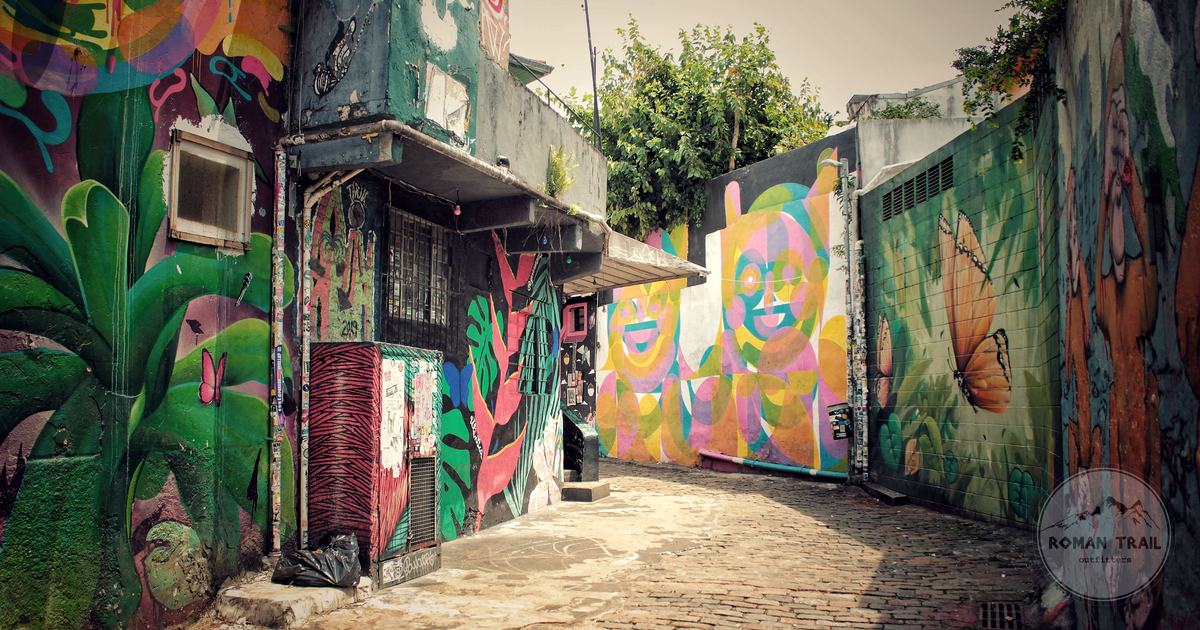 Colourful murals covering an alley wall in Sao Paulo, Sao Paulo packing list for women by Roman Trail Outfitters