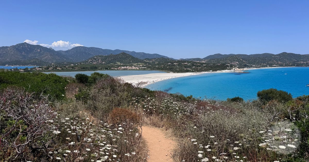 A coastal path above turquoise water in Sardinia, Italy