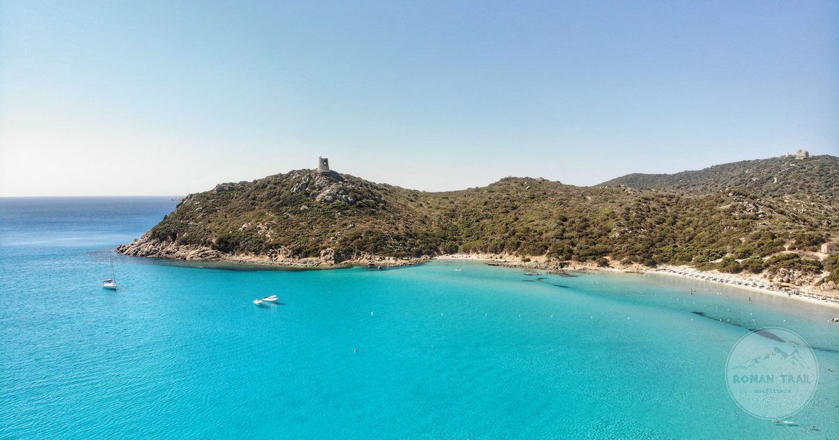 Aerial view of the Porto Giunco tower and turquoise water, Sardinia