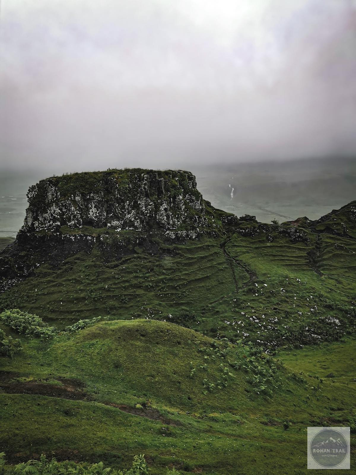 Aerial view of Scottish Highlands hiking terrain and misty hills for women travelers