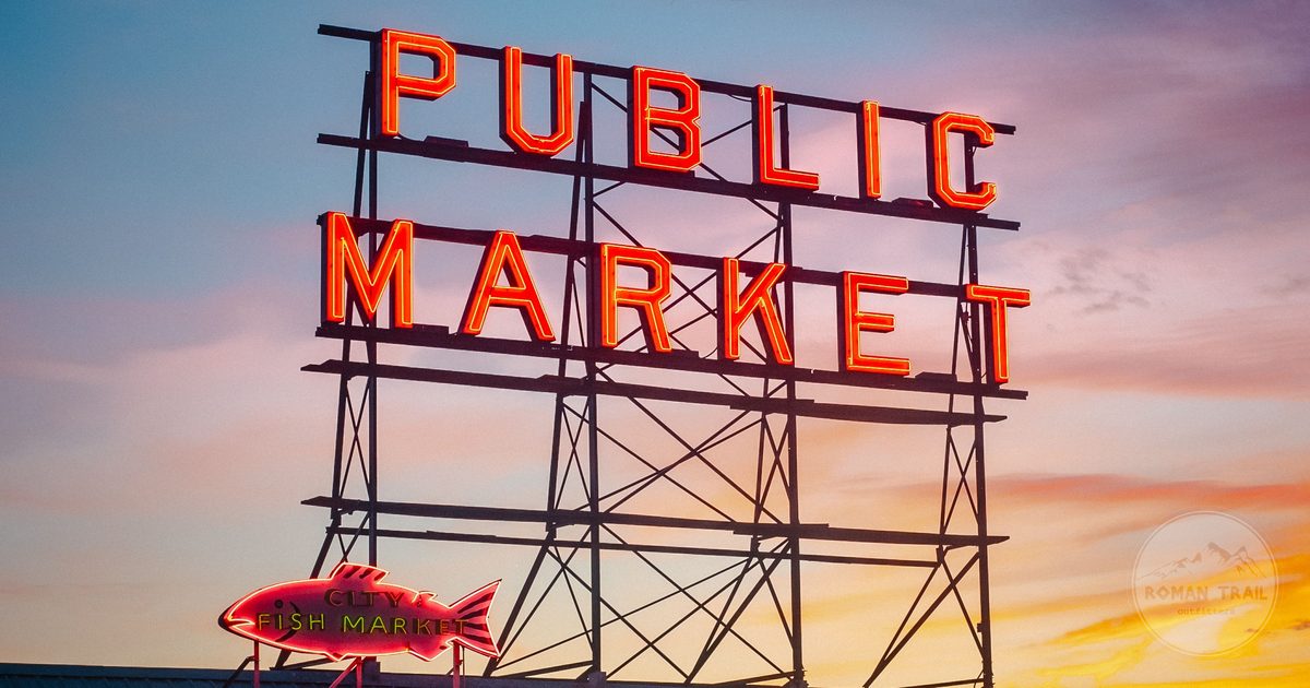 Illuminated Public Market sign at Pike Place Market at dusk, Seattle for women travelers