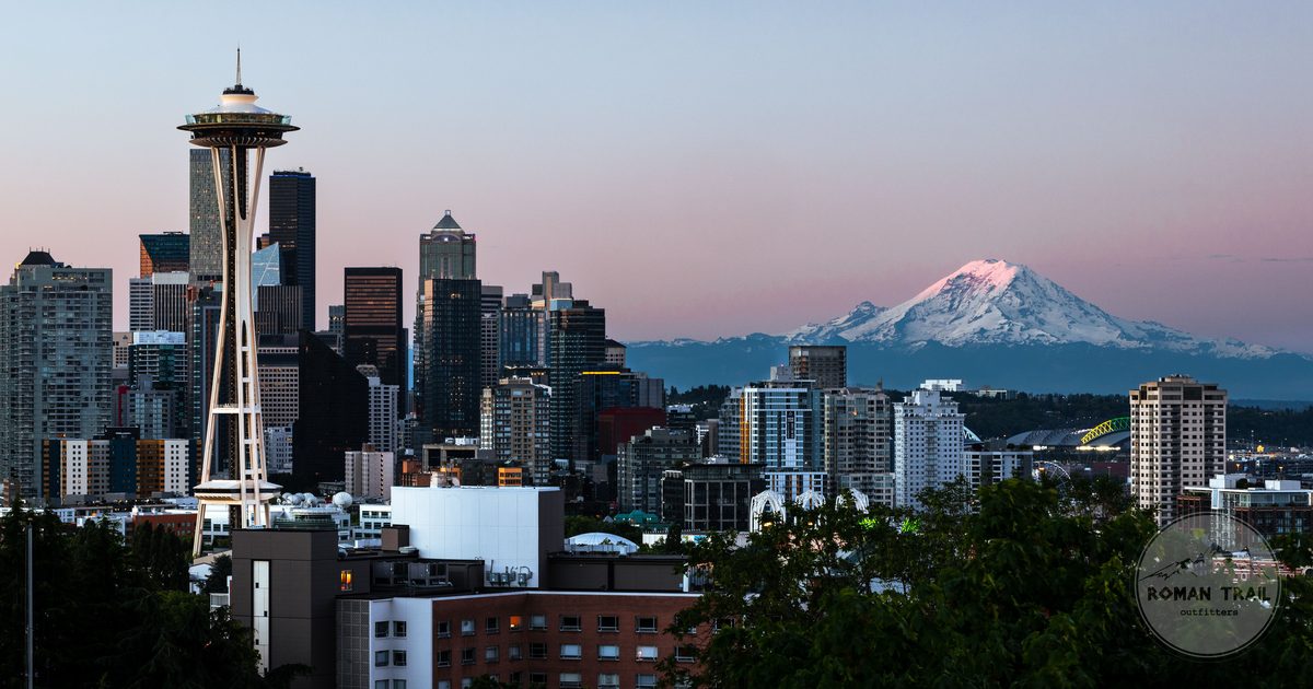 Seattle skyline with the Space Needle and Mount Rainier at dawn, Seattle travel guide for women by Roman Trail Outfitters