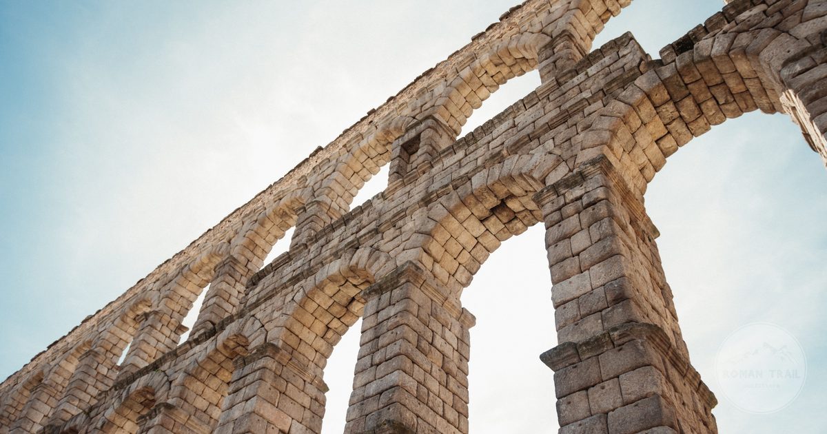 Low angle view of the stone arches of the Segovia aqueduct, Spain