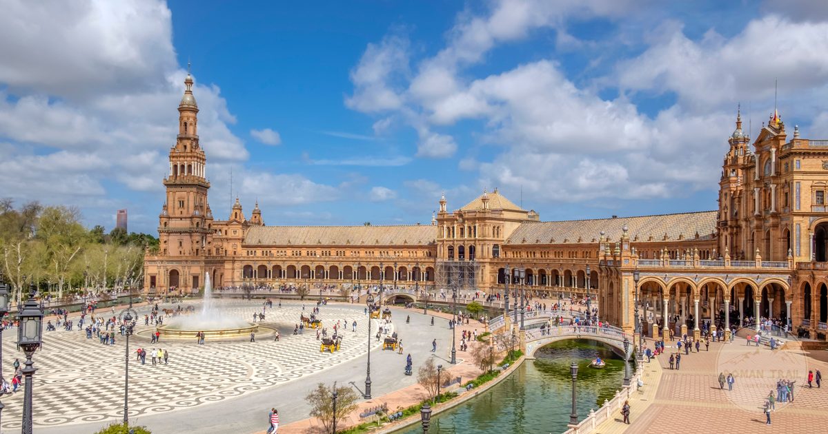 The full semicircular sweep of Plaza de Espana with its fountain and canal, Seville for women travelers