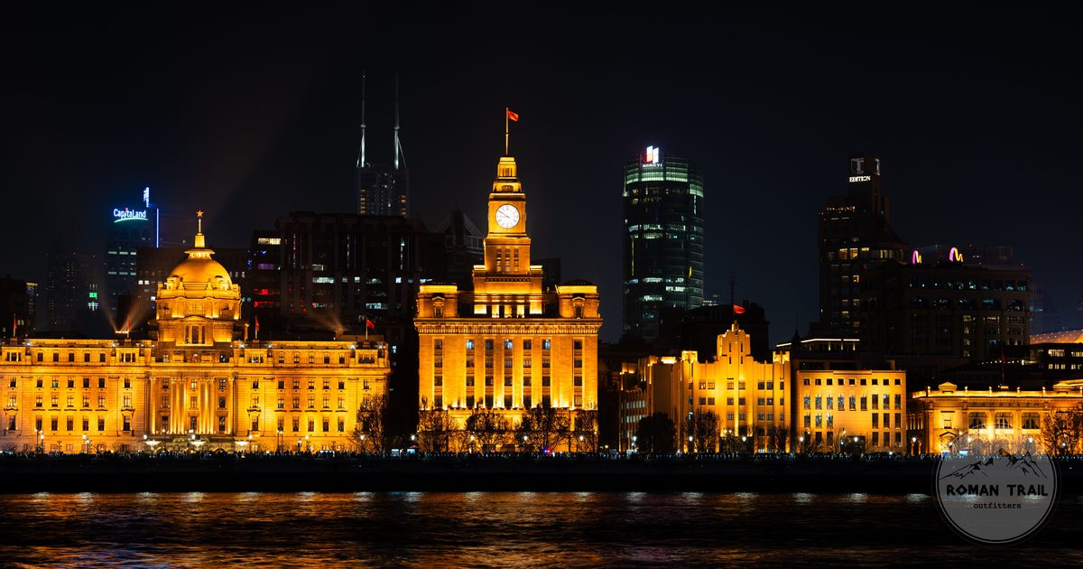 Illuminated Bund buildings reflected in the water, Shanghai, China