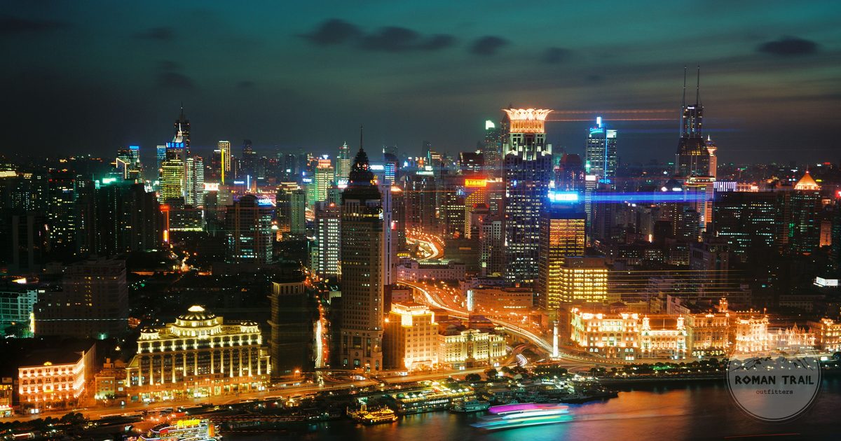 The illuminated Shanghai skyline at night over the river, China