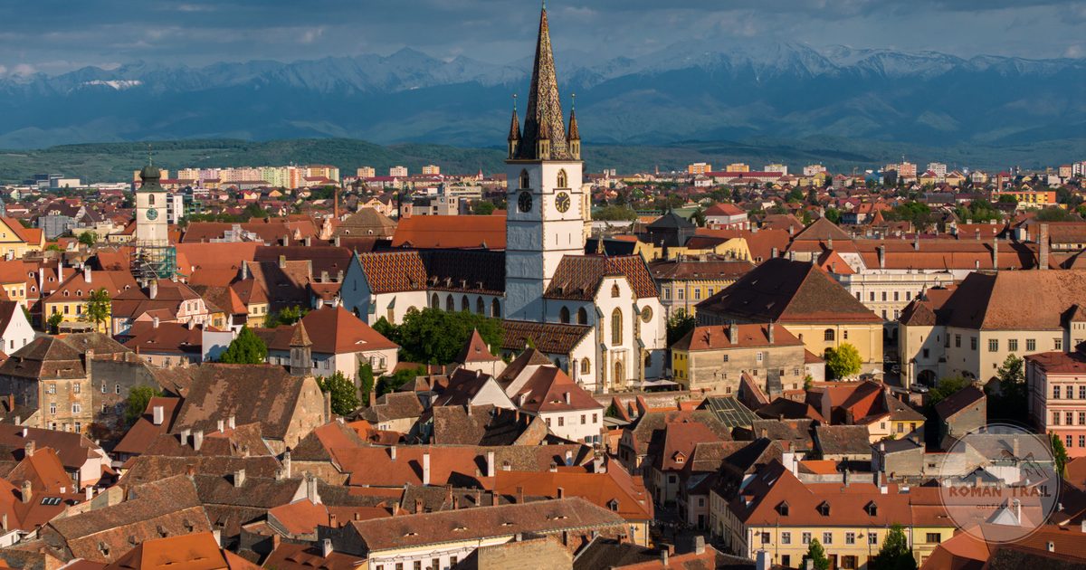 Aerial view of the historic architecture of Sibiu, Romania, with mountains behind