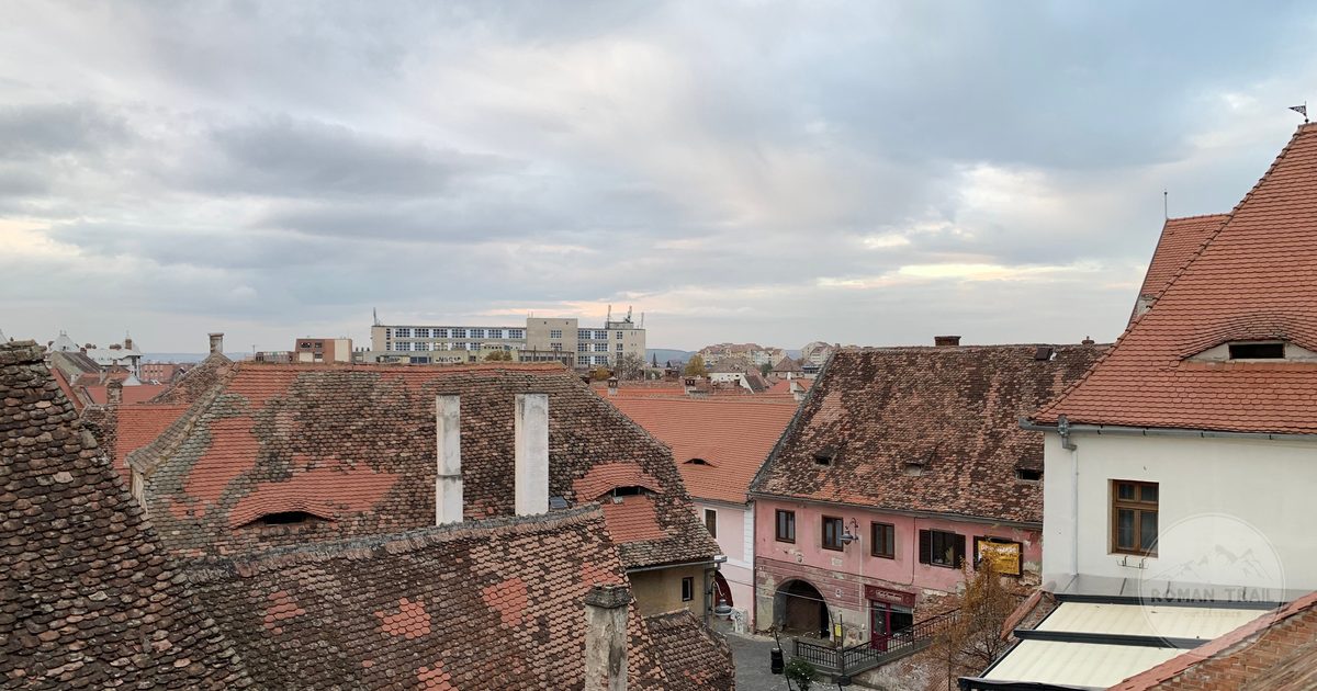 Historic rooftops in Sibiu, Romania, under a cloudy sky