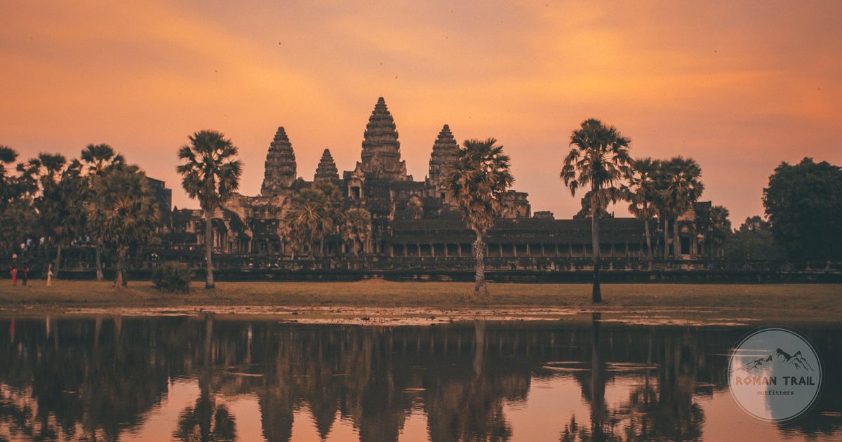 Angkor Wat at sunrise reflected in still water, Cambodia