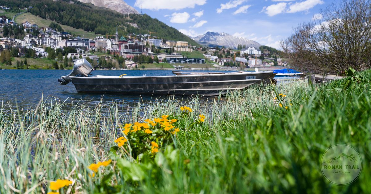 A boat on Lake St Moritz with flowers and mountains in summer, Switzerland
