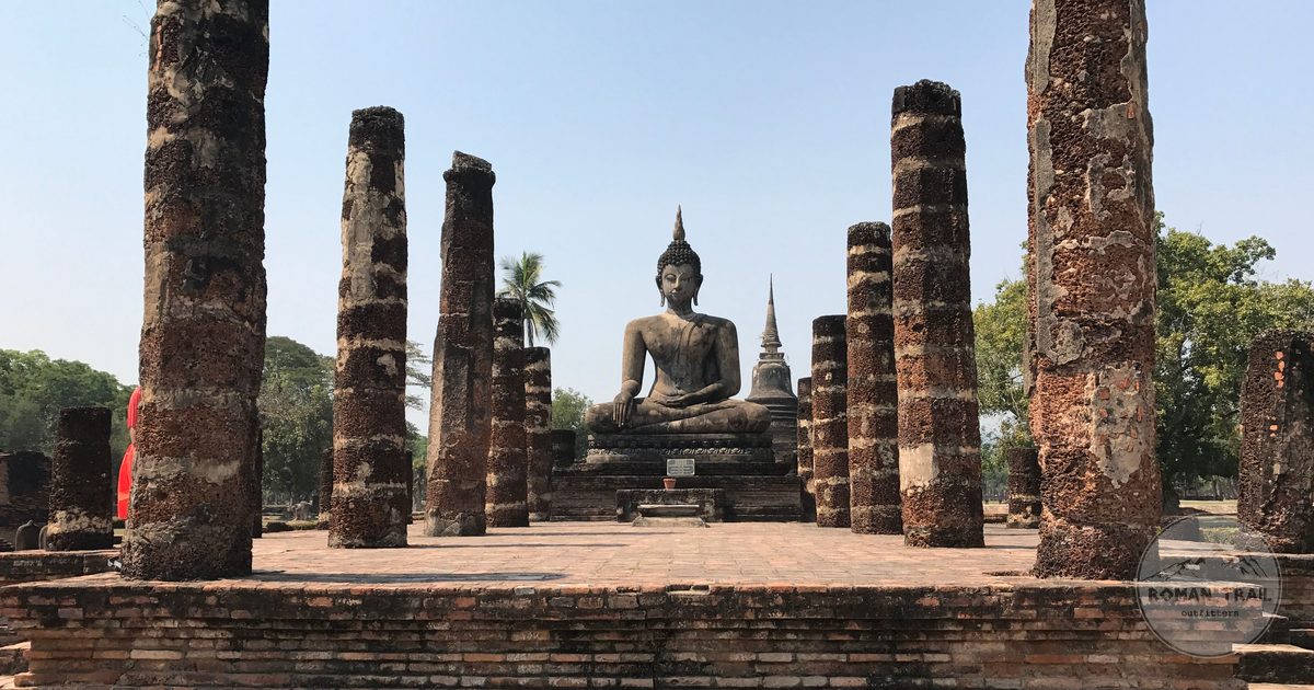 A Buddha statue among ancient columns at Sukhothai Historical Park, Thailand