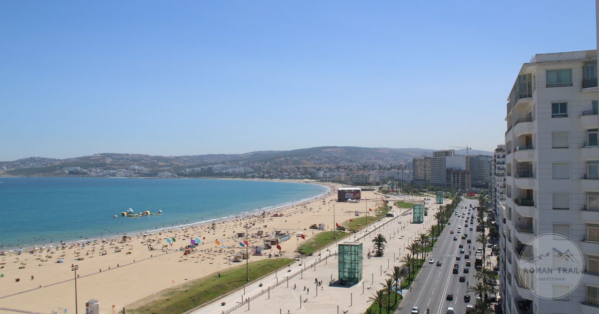 Aerial view of the sandy bay and city of Tangier on the Moroccan coast, Tangier packing list for women by Roman Trail Outfitters