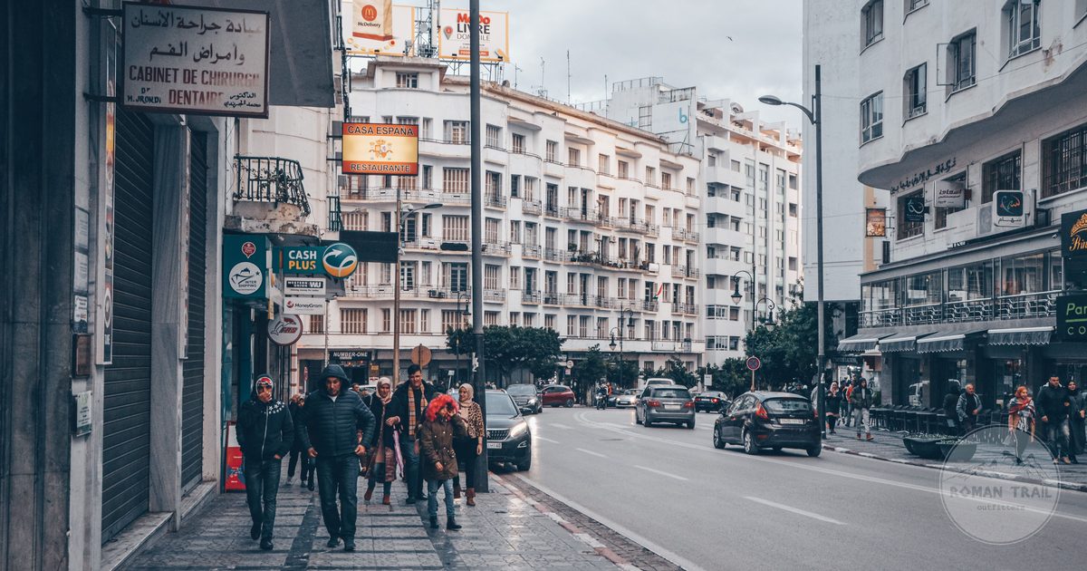 A busy street in central Tangier with pedestrians and cafes, Tangier packing list for women by Roman Trail Outfitters