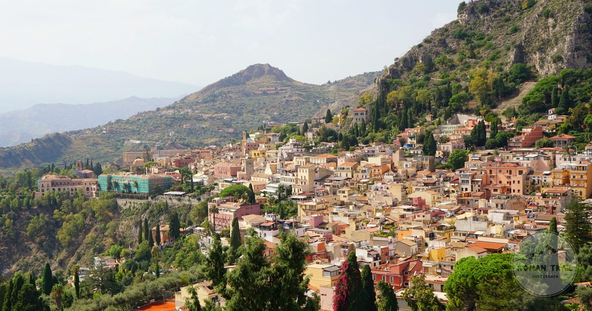 Aerial view of Taormina on its hillside above the coast, Sicily