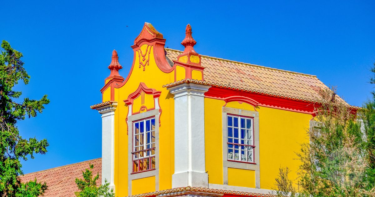 A yellow historic facade under a clear sky at Tavira, Portugal