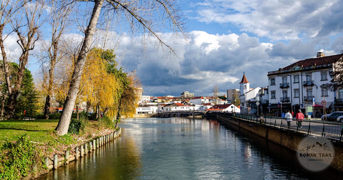 Autumn trees along the riverbank in the town of Tomar, Portugal