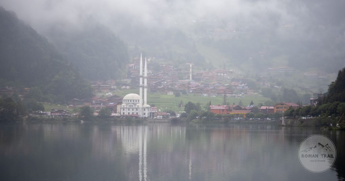 Uzungöl lake and its mosque below misty mountains in Trabzon province, Turkey