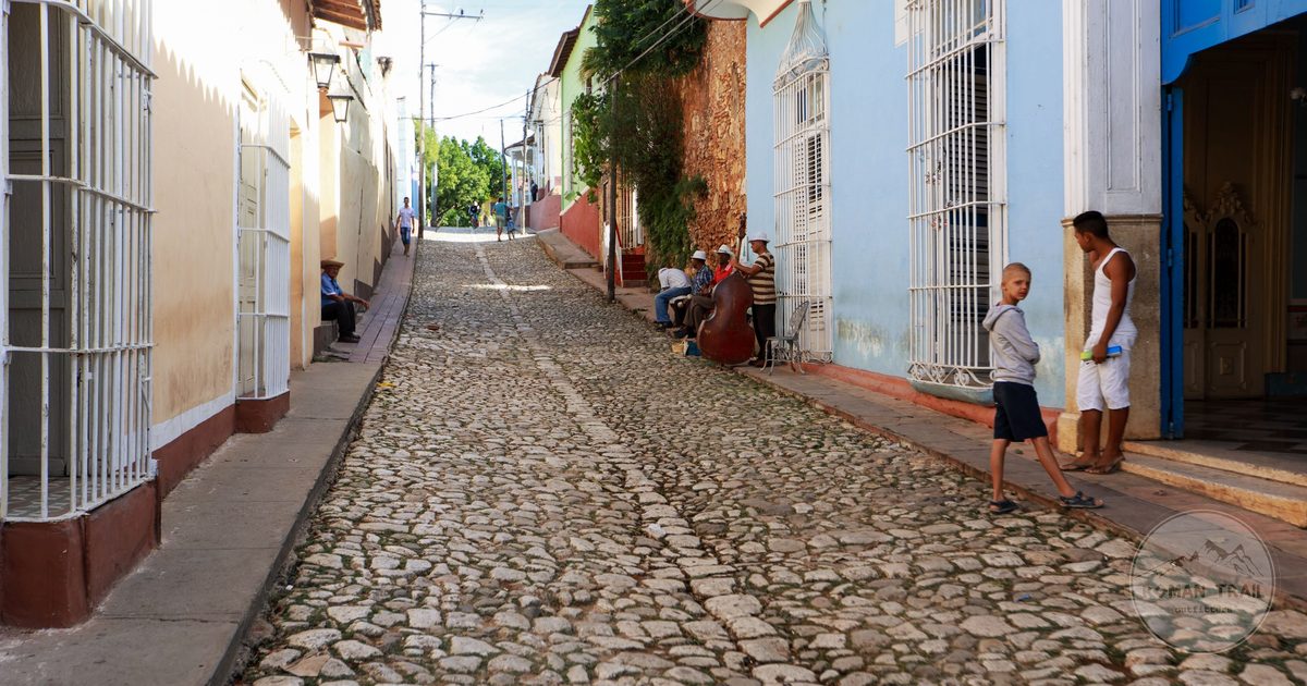 A cobblestone street lined with colourful houses in Trinidad, Cuba
