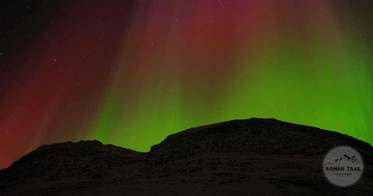 Aurora borealis over mountains near Tromso, Norway