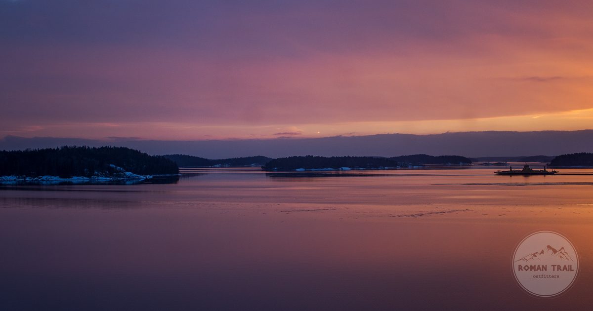 Sunset over the Finnish archipelago with reflections on the water