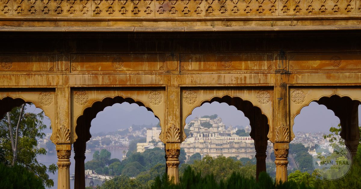 Udaipur palace framed by an ornate historic archway, Rajasthan, India
