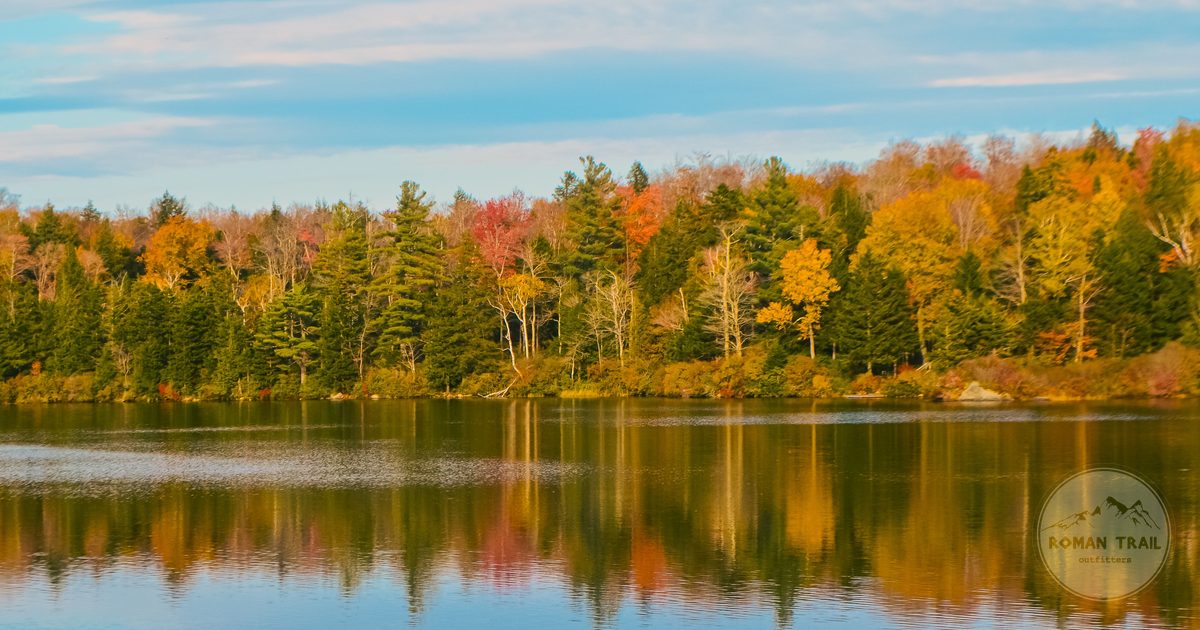 Autumn foliage reflected in a calm lake in Vermont, New England