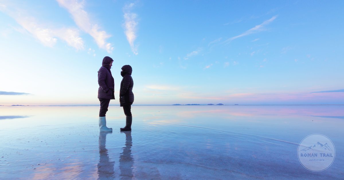 Silhouettes reflected on the mirrored surface of the Uyuni salt flats