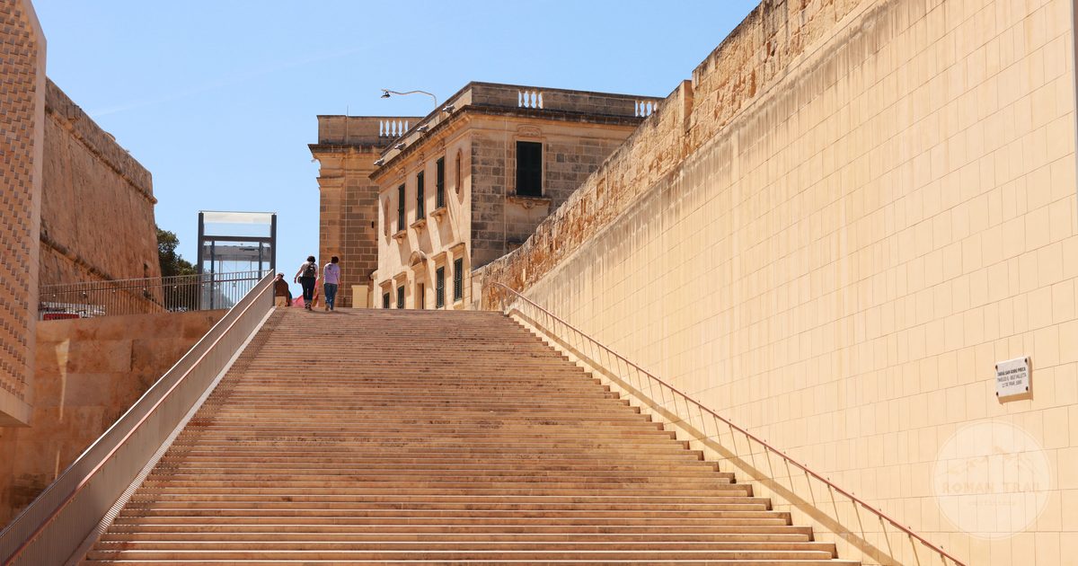 Stone steps rising between historic buildings in Valletta, Malta