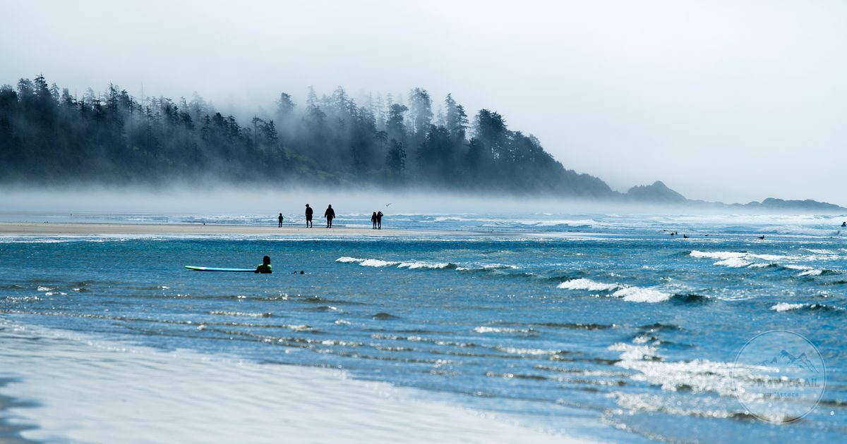Surfers on the foggy beaches at Tofino, British Columbia, Canada