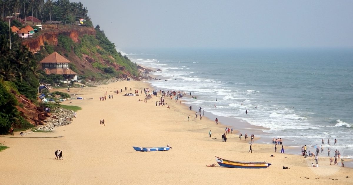 Varkala Beach below its cliffs with boats and visitors, Kerala, India